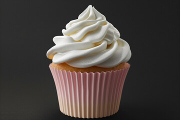 a cupcake with white frosting on a black surface