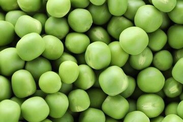 Fresh raw green peas as background, top view