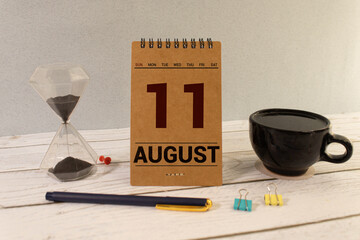 August 11th. August 11 wooden cube calendar with blur objects on background