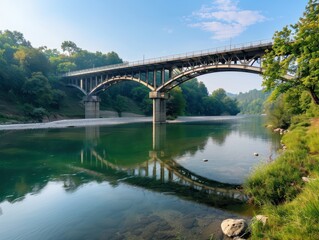 Fototapeta premium Stunning Full Vista of a Historic Arch Bridge Spanning a Serene River, A Testament to Engineering Marvel, Capturing the Beauty of Nature and Architectural Brilliance