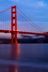 The Golden Gate Bridge reflected in the San Francisco Bay in early morning light.