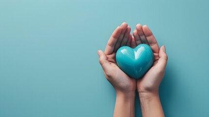 Obraz premium Young women hands holding blue heart on blue background, health care, donate and family insurance concept,world heart day, world health day, CSR responsibility, Mother's day