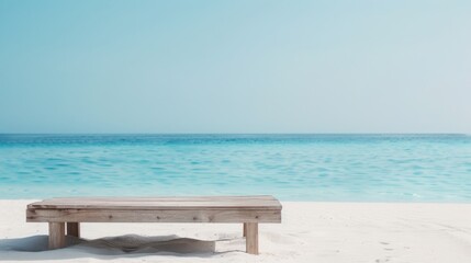 Serene Seaside Setting - Wooden Table on Sandy Beach with Blue Sea and Clear Sky Backdrop