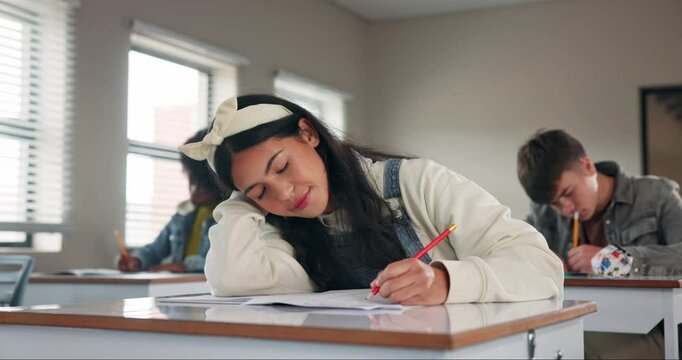Education, exhausted and writing with girl student in class for development, learning or study. Book, bored or burnout and tired teen in classroom with assessment, growth or scholarship fatigue