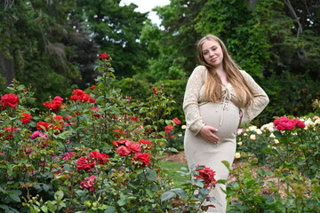 pregnant woman in the park with roses