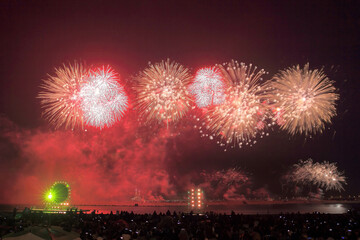 Night view of crowd with fireworks on Incheon Bridge and sea at Songdo-dong of Yeonsu-gu, Incheon, South Korea
