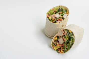 healthy green lettuce and chicken salad wrap.