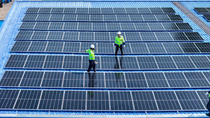 engineer man inspects construction of solar cell panel or photovoltaic cell by electronic device....