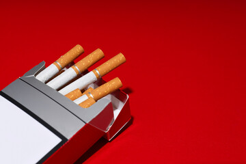 A pack of cigarettes on a red background