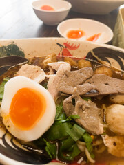 Hot and spicy Thai noodle soup with soft boiled egg