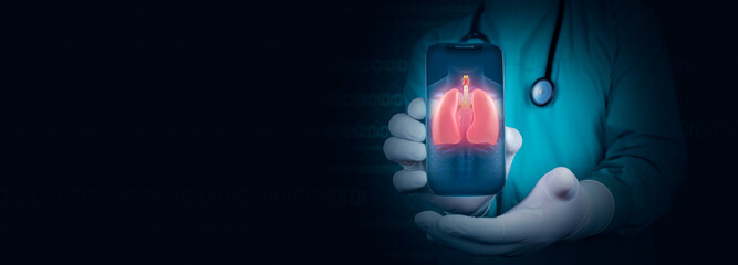 The doctor shows an illustration of the lungs, through his cell phone, telemedicine concept. Doctor...