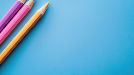 Obraz premium Color pencil close up on blue background with space for copy