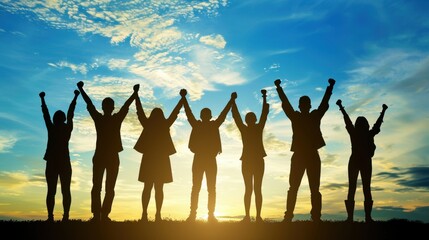 Silhouette of a team standing in a line with raised arms, celebrating success against a sunset background
