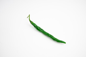 Single curly green chili. typical Indonesian, isolated on a white background.