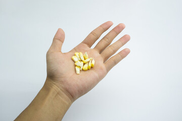 Cracked corn in human hand. isolated on white background