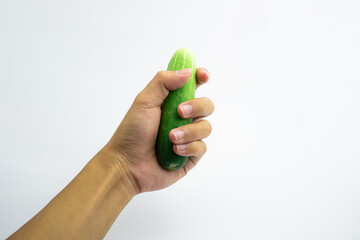 Human hand is holding a cucumber. isolated on white background.