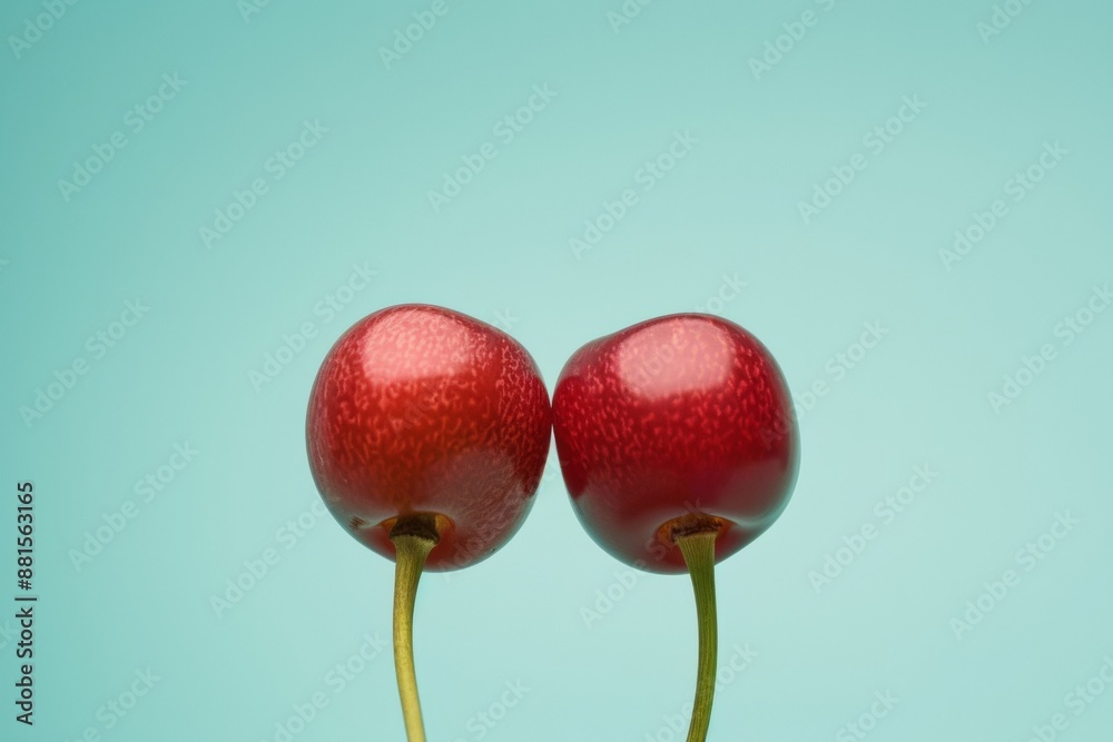 Poster symmetrical abstract photography of two red cherries against a sky blue background captured with a l