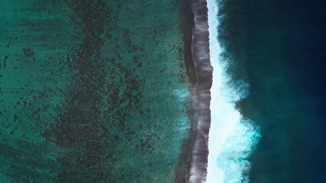 Waves crashing mid colorful aqua turquoise shallow coral reef Teahupoo Tahiti aerial drone birdseye view perspective French Polynesia surf wave Pacific Ocean Channel Point Faremahora Pass Havae upward