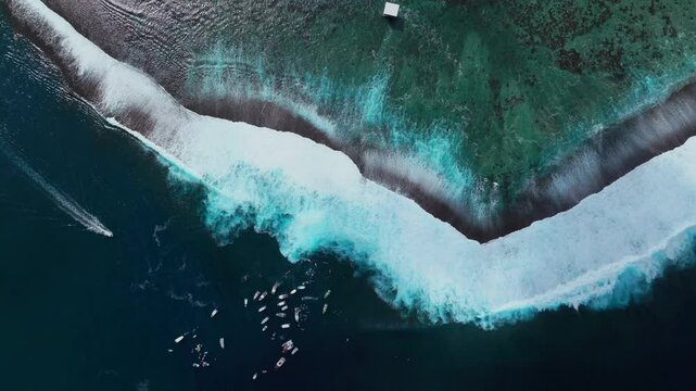 Surfing waves crashing on shallow reef Teahupoo Tahiti aerial drone birds eye view French Polynesia boats jetski surfer 2024 surf judge tower Pacific Ocean Channel Point Faremahora Pass Havae static