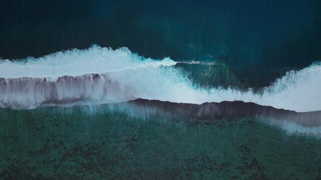 Waves crashing mid colorful aqua turquoise shallow coral reef Teahupoo Tahiti aerial drone birdseye view perspective French Polynesia surf wave Pacific Ocean Channel Point Faremahora Pass Havae static