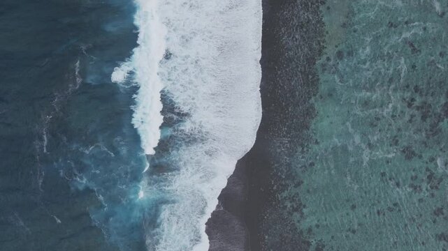 Waves crashing mid colorful aqua turquoise shallow coral reef Teahupoo Tahiti aerial drone birdseye view perspective French Polynesia surf wave Pacific Ocean Channel Point Faremahora Pass Havae still