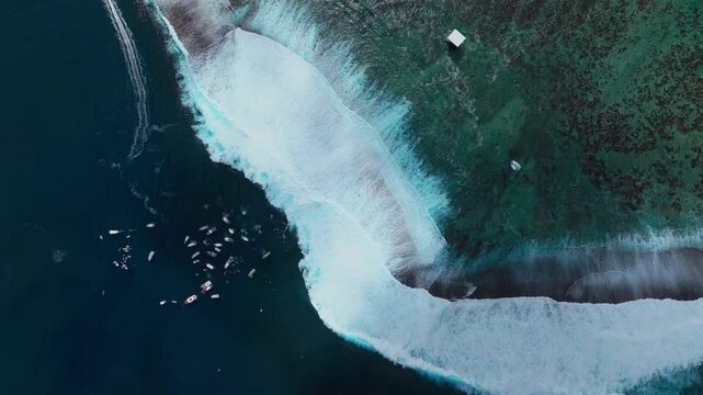 Surfing waves crashing on shallow reef Teahupoo Tahiti aerial drone birds eye view French Polynesia boats jetski sunny 2024 surf judge tower Pacific Ocean Channel Point Faremahora Pass Havae static