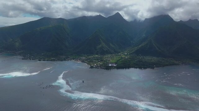 Coastal Teahupoo Tahiti aerial drone view perspective French Polynesia coral reef surf break waves mountains Pacific Ocean channel boats cloudy sunny daytime Point Faremahora Pass Havae circle left