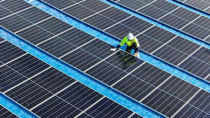 Worker Technicians are working to construct solar panels system on roof. Installing solar...