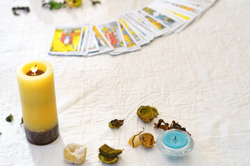 Fototapeta premium table of a fortune teller with tarot cards, candles, quartz stones,