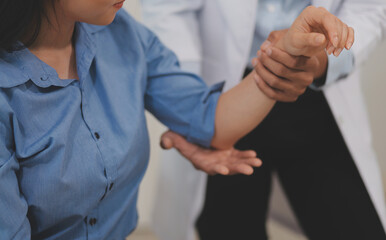 Obraz premium Doctor or Physiotherapist working examining treating injured arm of athlete male patient, stretching and exercise, Doing the Rehabilitation therapy pain in clinic.