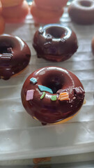 Fresh baked mini donuts with different flavors.