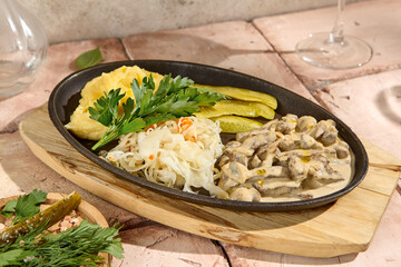 Authentic Beef Stroganoff with Mashed Potatoes, Pickle, and Cabbage in Natural Sunlight