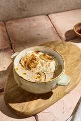 Still Life of Authentic Mushroom Cream Soup with Whipped Cream Mousse in Natural Sunlight