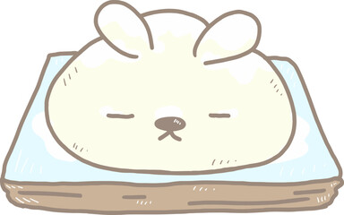 Cartoon mochi in the shape of a rabbit with closed eyes made from soft mochi dough. on a blue plate and sprinkled with icing sugar