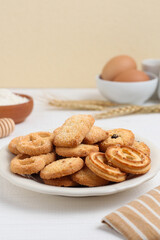 Danish butter cookies on a white plate on a white table. Perfect for recipe, design element, article, or any commercial purposes.