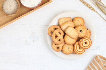 Danish butter cookies on a white plate on a white table. Perfect for recipe, design element, article, or any commercial purposes.