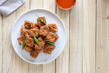 Sumedang tofu (tahu sumedang) on a wooden table. Perfect for recipe, article, catalogue, or any commercial purposes.