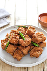 Sumedang tofu (tahu sumedang) on a wooden table. Perfect for recipe, article, catalogue, or any commercial purposes.