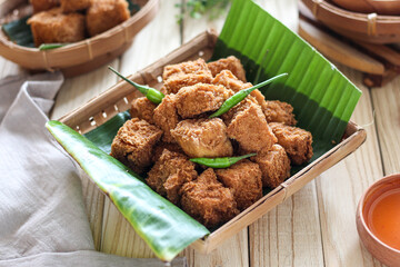 Sumedang tofu (tahu sumedang) on a wooden table. Perfect for recipe, article, catalogue, or any commercial purposes.
