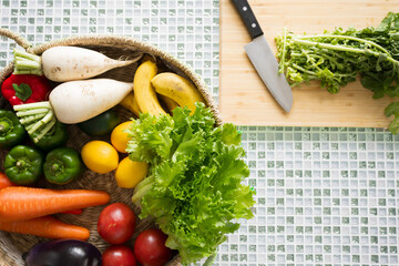 Fresh vegetables, knives and cutting boards Overhead view of the kitchen