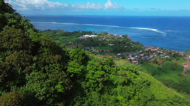 Teahupoo Tahiti aerial drone over mountains view French Polynesia coastline town village new Olympic 2024 sunny surf waves channel Point boats river Faremahora Pass Havae forward pan up slowly
