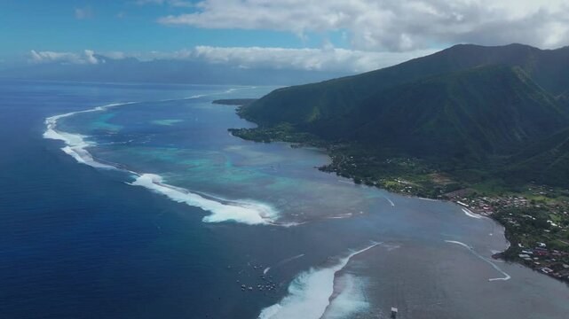 Coastal Teahupoo Tahiti aerial drone view new judge tower surfing contest Point Faremahora Pass Havae French Polynesia coral reef surf break waves Pacific Ocean channel boats cloudy sunny circle left