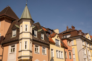 Altschwabing, district in Munich, Bavaria, Germany. Colorful house facades and roofs of a historic row of houses with turrets and gables.