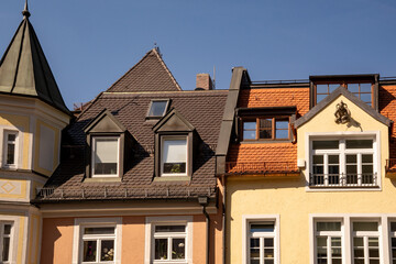 Altschwabing, district in Munich, Bavaria, Germany. Colorful house facades and roofs of a historic row of houses with turrets and gables.