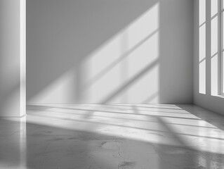 empty room interior with gray walls and the sun beaming through a nearby window