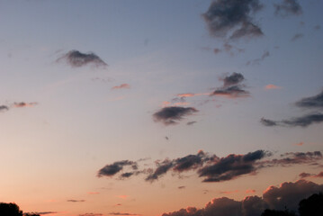  photo of a cloudy sky at sunset, with pink and orange hues.