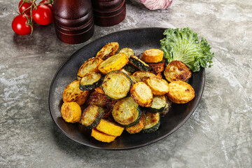 Roasted young zucchini in the plate