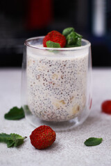 A delicious chia pudding dessert topped with fresh strawberries and mint offers the perfect blend of taste and health.