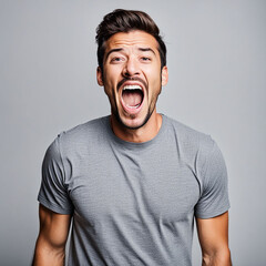 Excited Man in Stylish Blue T-Shirt Celebrating Victory in Studio