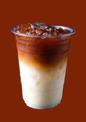Thai tea with milk and ice in plastic glasses isolated. On brown background. 